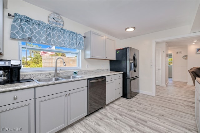 kitchen featuring stainless steel appliances, light hardwood / wood-style floors, and sink