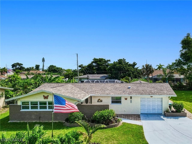 ranch-style house featuring a garage and a front lawn