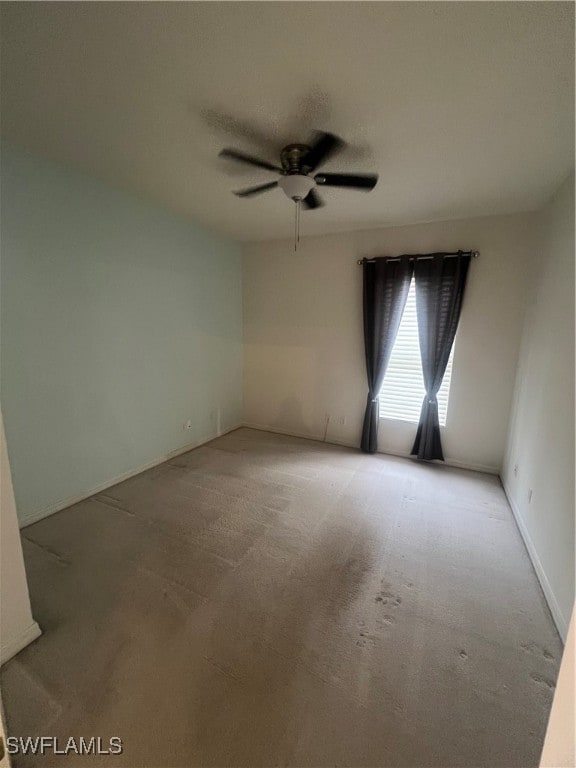 spare room featuring ceiling fan and light carpet