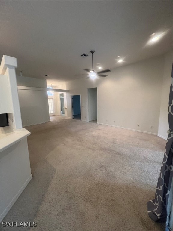 unfurnished living room with carpet flooring and ceiling fan