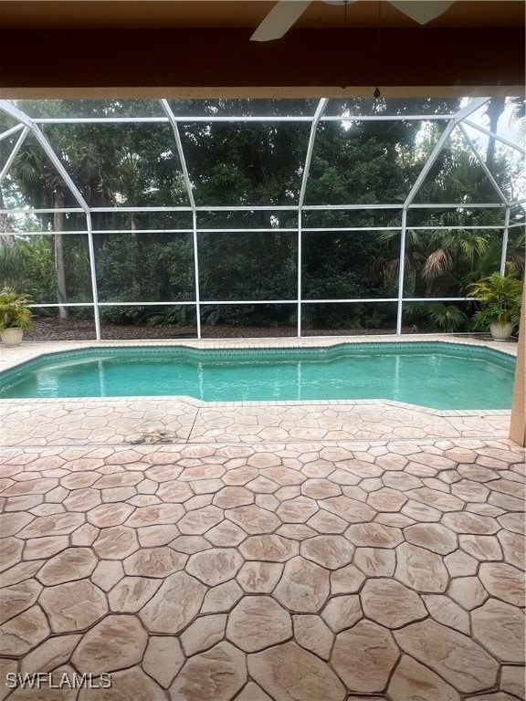 view of swimming pool with a patio and a lanai