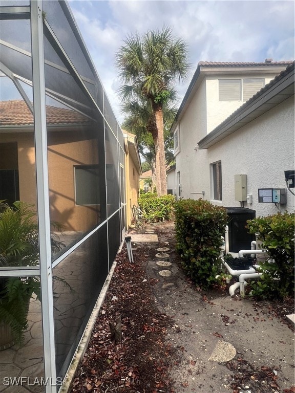 view of side of home with a lanai