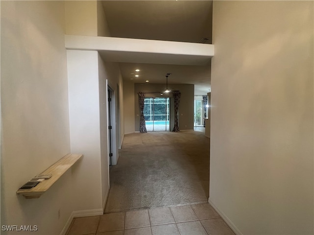 hall featuring light tile patterned flooring