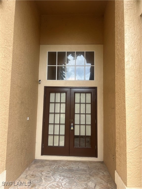 view of exterior entry featuring french doors