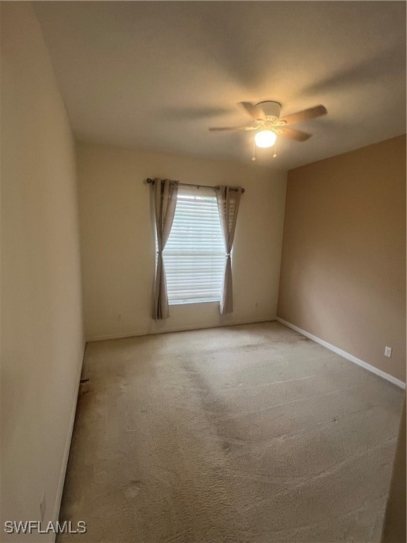 carpeted empty room with ceiling fan