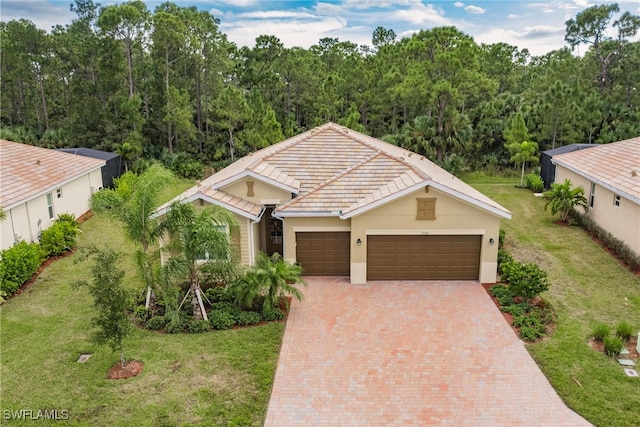 view of front of house featuring a garage and a front lawn