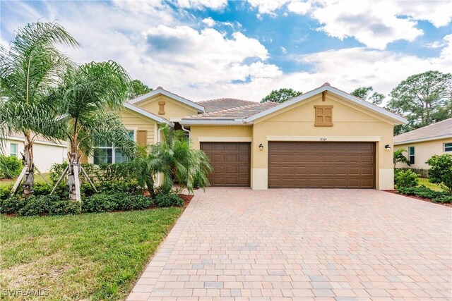 ranch-style home with a garage and a front yard