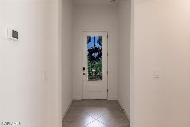 doorway featuring light tile patterned flooring