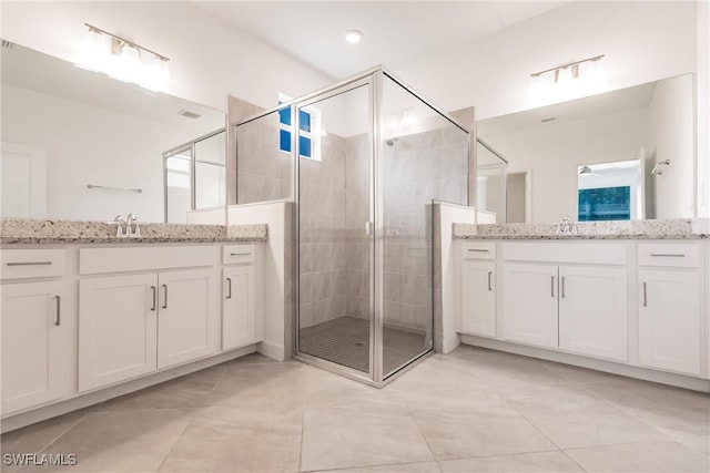 bathroom featuring vanity, tile patterned floors, and a shower with door