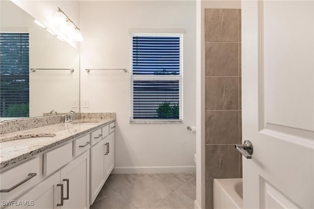 bathroom with vanity, toilet, a tub to relax in, and tile patterned floors