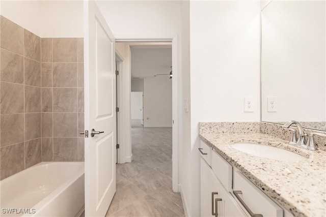 bathroom featuring vanity and a bath