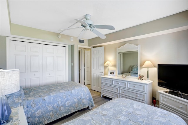 bedroom featuring hardwood / wood-style floors, ceiling fan, and a closet