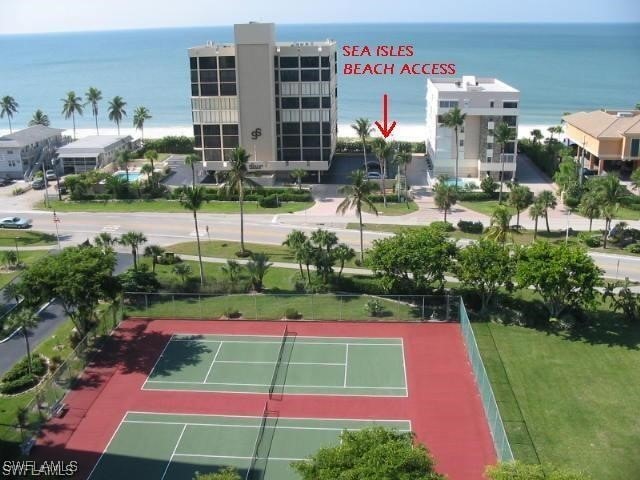 view of tennis court featuring a water view