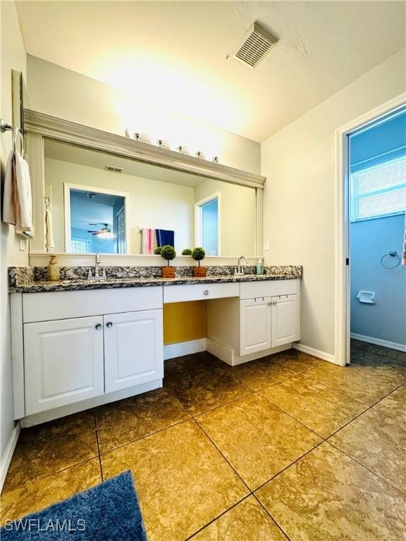 bathroom with tile patterned flooring and vanity