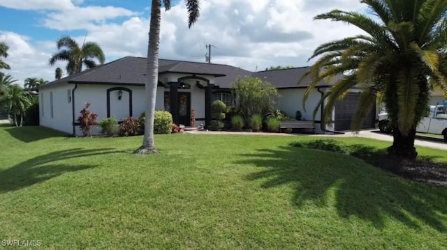 single story home with a garage and a front lawn