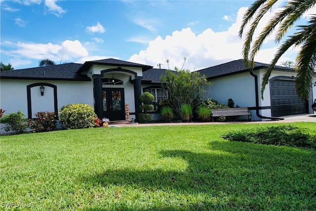 ranch-style house featuring a front lawn and a garage