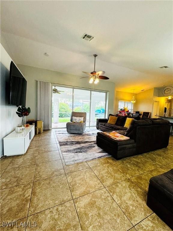 tiled living room with ceiling fan