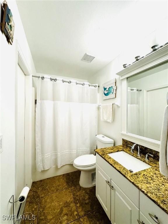 full bathroom with vanity, toilet, and shower / tub combo