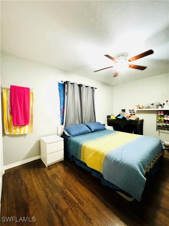 bedroom with ceiling fan and dark hardwood / wood-style floors