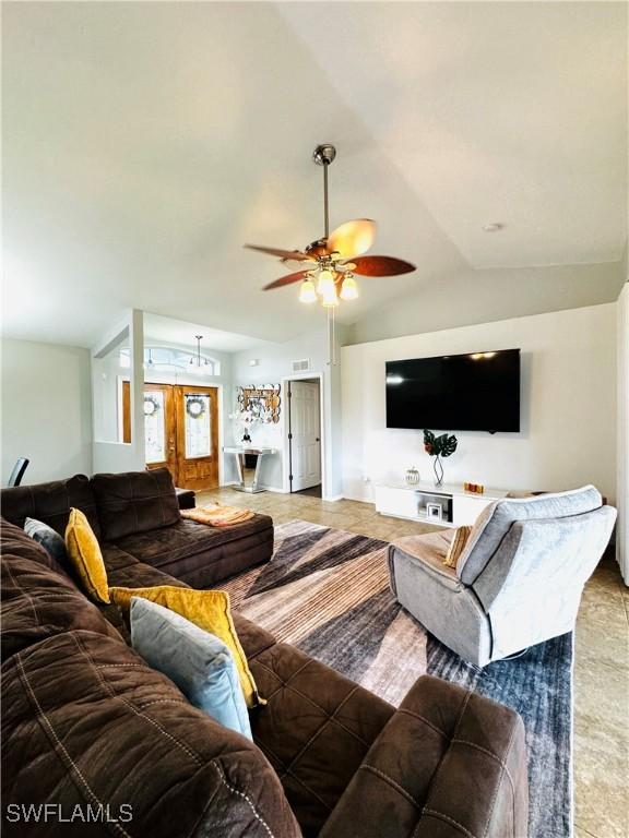 living room with vaulted ceiling and ceiling fan