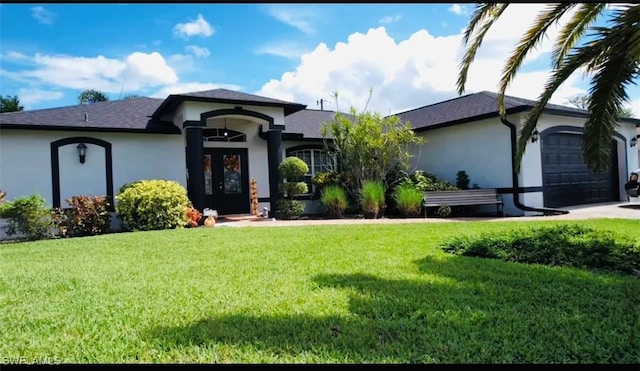 view of front of property with a front yard and a garage