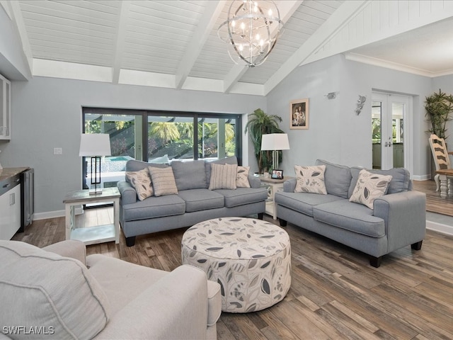 living room with lofted ceiling with beams, an inviting chandelier, dark wood-type flooring, and french doors