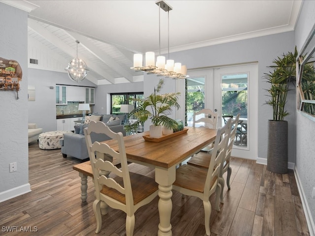 dining space featuring lofted ceiling with beams, a wealth of natural light, french doors, and dark hardwood / wood-style flooring