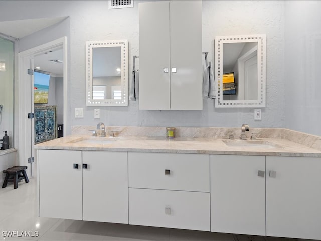 bathroom with tile patterned flooring and vanity