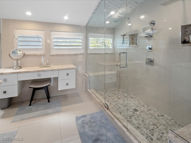 bathroom featuring vanity, tile patterned floors, and a shower with door