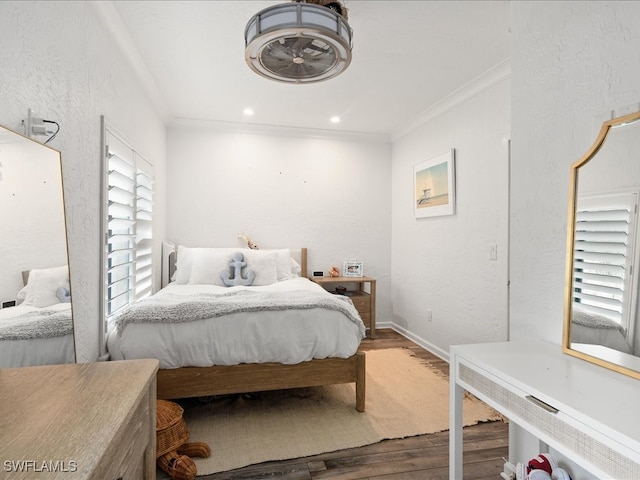 bedroom with crown molding and hardwood / wood-style flooring