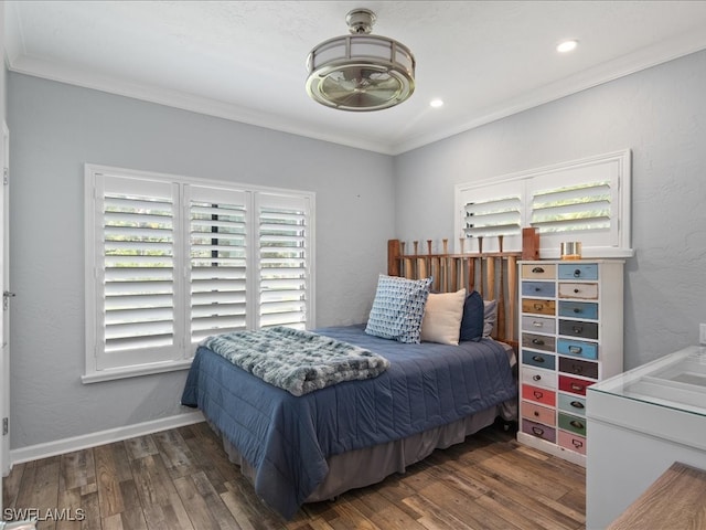 bedroom with dark hardwood / wood-style floors and crown molding