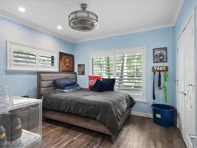 bedroom featuring ornamental molding and dark wood-type flooring