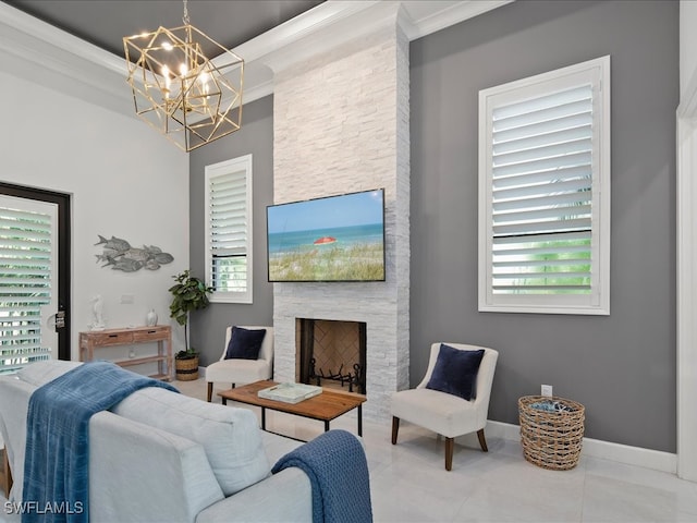 living room featuring a stone fireplace, ornamental molding, a chandelier, and a wealth of natural light