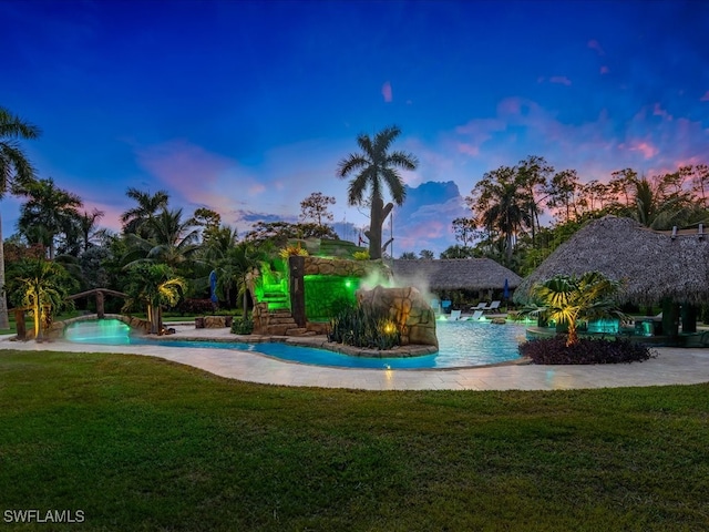 view of property's community with a lawn and a pool