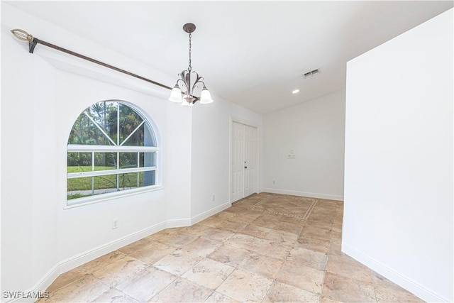 empty room with a notable chandelier, recessed lighting, visible vents, baseboards, and stone finish floor