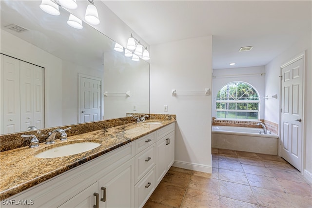 bathroom with vanity and a relaxing tiled tub