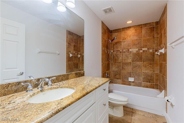 full bathroom with vanity, tiled shower / bath combo, and toilet