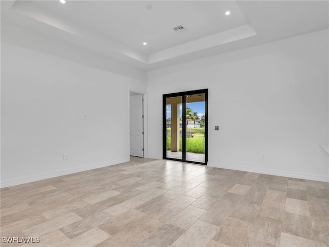 empty room with a tray ceiling and a high ceiling