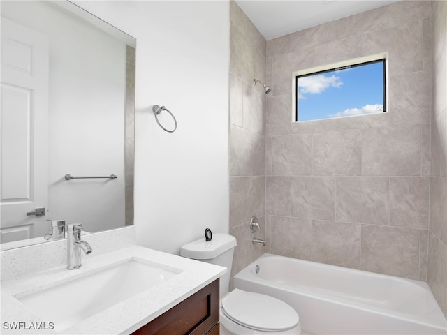 full bathroom with tiled shower / bath combo, vanity, and toilet