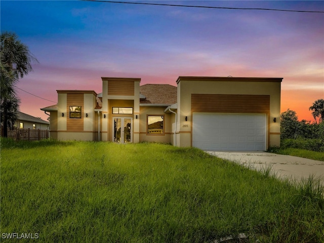 contemporary house with a yard and a garage