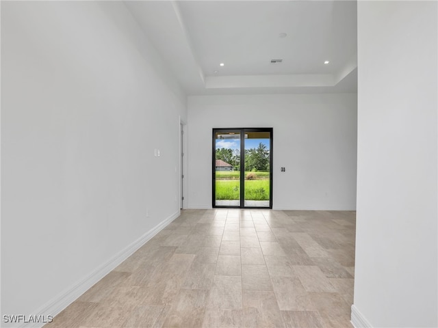 spare room featuring a raised ceiling