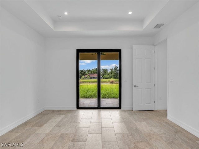 empty room with a raised ceiling