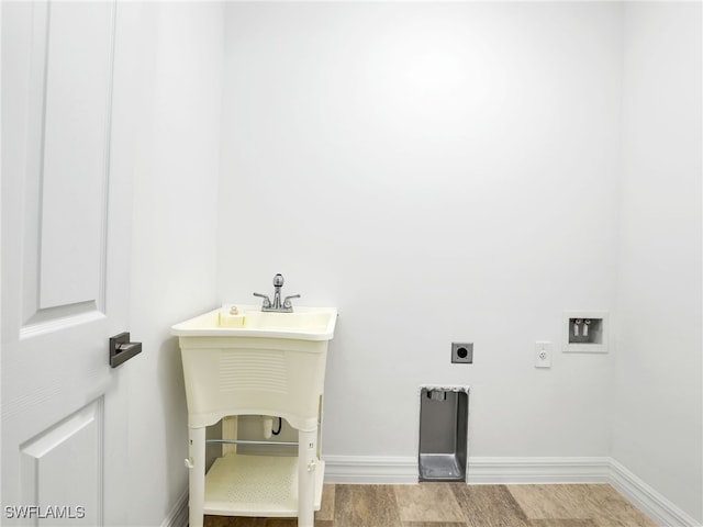 laundry area featuring light hardwood / wood-style floors and electric dryer hookup