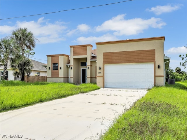 contemporary home featuring cooling unit and a garage