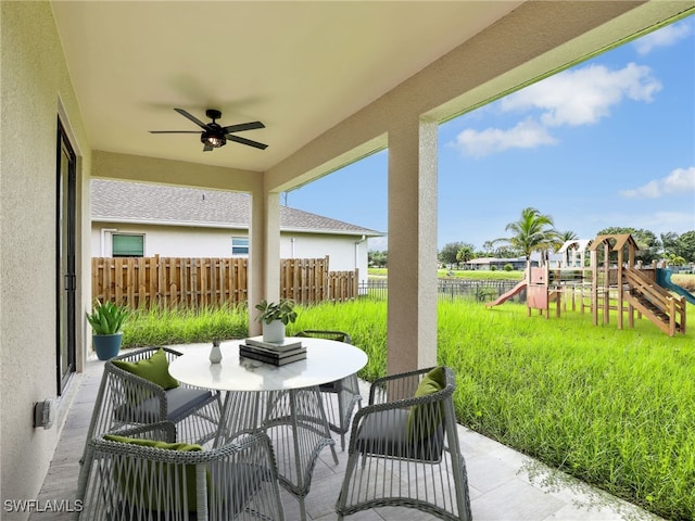 view of patio featuring a playground and ceiling fan