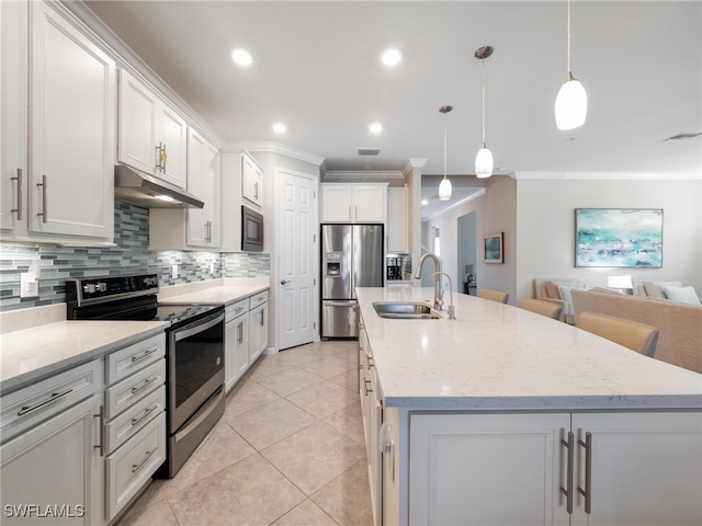 kitchen with pendant lighting, sink, an island with sink, white cabinets, and stainless steel appliances