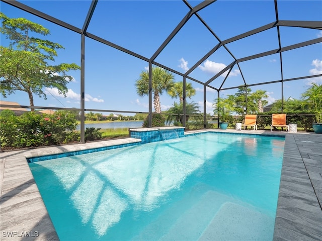 view of pool with a patio, a water view, and a lanai