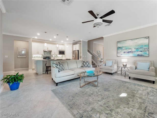 living room featuring ceiling fan, light tile patterned flooring, and crown molding