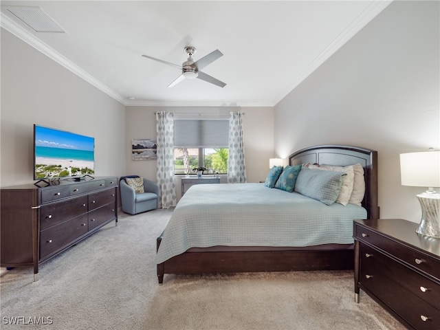 carpeted bedroom featuring ceiling fan and crown molding