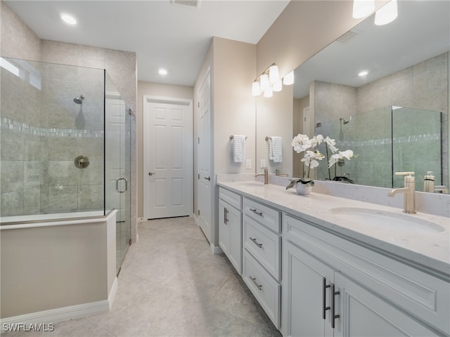 bathroom featuring walk in shower, tile patterned flooring, and vanity